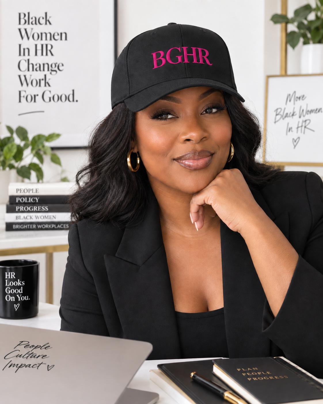 Black woman wearing the black BGHR cap with dark pink embroidery in a professional office